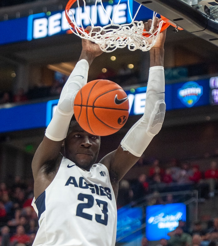 (Rick Egan  |  The Salt Lake Tribune)   Utah State Aggies center Neemias Queta (23) dunks the ball, as Weber State Wildcats forward Michal Kozak (11) defends, in basketball action in the Beehive Classic, between against the Utah State Aggies and Weber State Wildcats, a the Vivint Smart Home Arena, Saturday December 8, 2018.

 