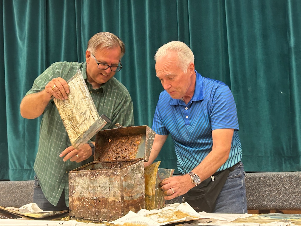 (Samantha Moilanen | The Salt Lake Tribune) Jordan North 6th Ward Bishop Brent Newton, left, and Jordan North 5th Ward Bishop Steve Jester pull church documents from 1980 out of a time capsule at a Latter-day Saint meetinghouse in West Valley City on Saturday, Sept. 26, 2026.