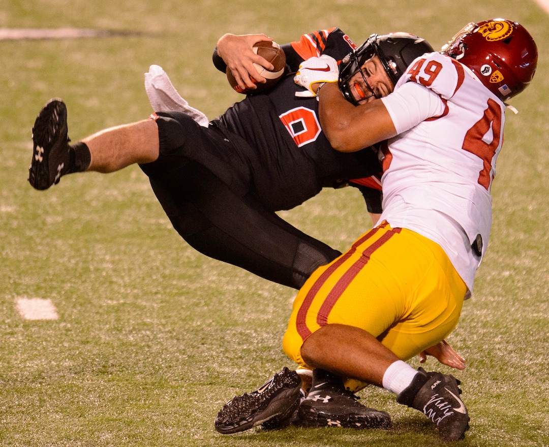 (Trent Nelson  |  The Salt Lake Tribune) USC Trojans defensive lineman Tuli Tuipulotu (49) sacks Utah Utes quarterback Jake Bentley (8), as the Utah Utes host the USC Trojans, NCAA football at Rice-Eccles Stadium in Salt Lake City on Saturday, Nov. 21, 2020.