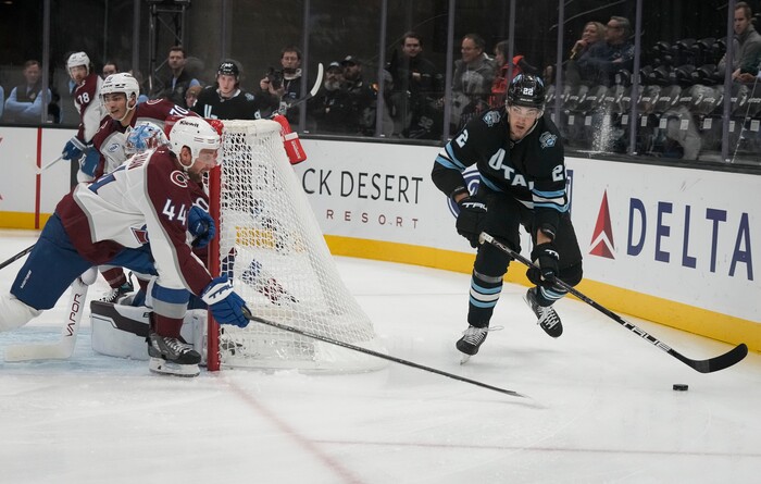 (Bethany Baker | The Salt Lake Tribune) Utah Hockey Club center Jack McBain (22) skates behind the goal as Colorado Avalanche defenseman Calvin de Haan (44) defends during the game between the Utah Hockey Club and the Colorado Avalanche at the Delta Center in Salt Lake City on Thursday, Oct. 24, 2024.