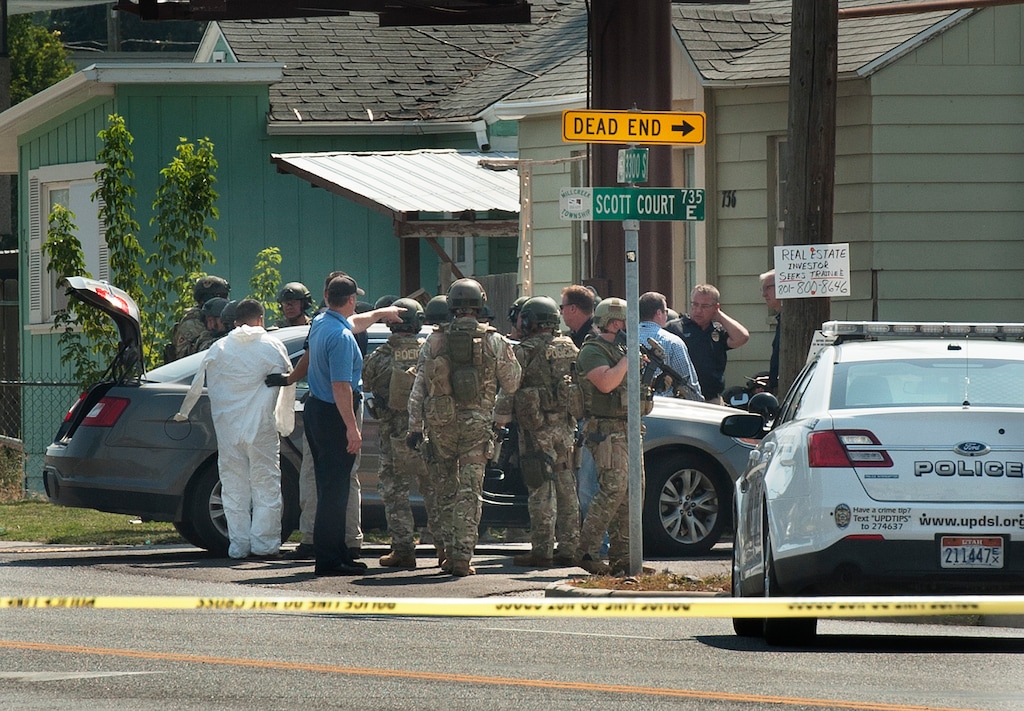 Scott Sommerdorf   |  The Salt Lake TribuneUnified Police apprehend a suspect at far left, that they put a white jumpsuit on to maintain evidence that may be on his person. The suspect had heavily barricaded himself in a home after shooting a woman who had come to try to calm down a domestic dispute near 3300s and 700e. 