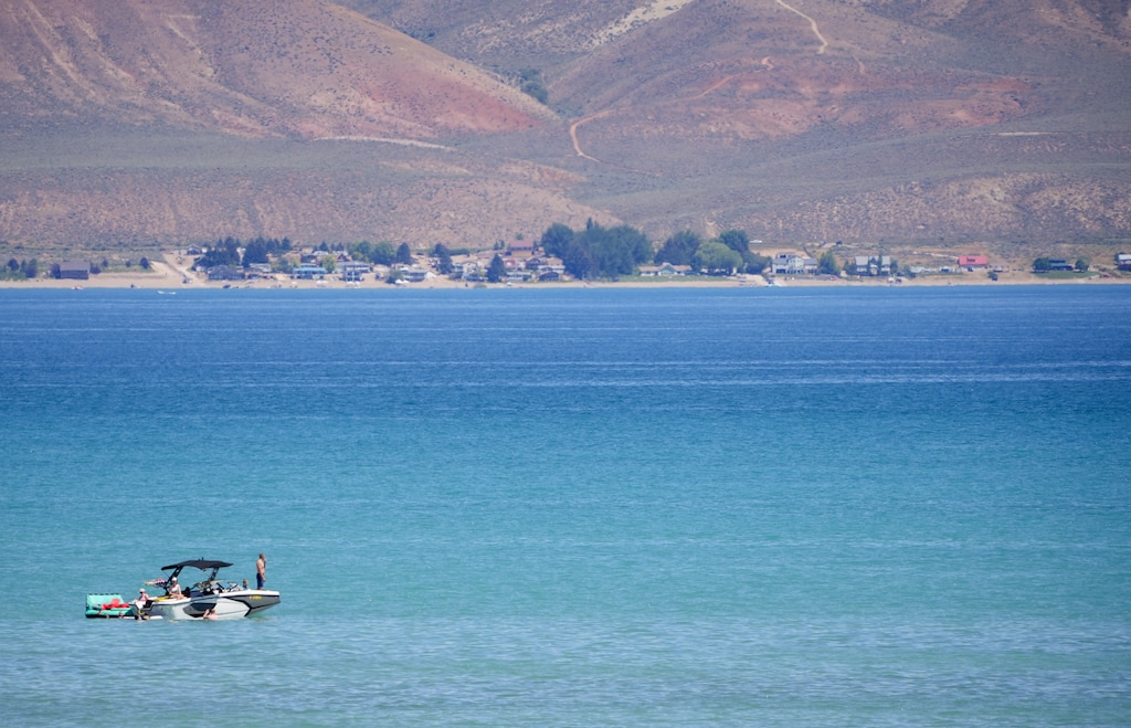 (Chris Samuels | The Salt Lake Tribune) A boat floats on Bear Lake in Fish Haven, Idaho, Friday, July 11, 2025. Bear Lake Watch, a nonprofit focused on research and advocacy, is raising money to open a new invasive species check station on the Gem State side of the lake.