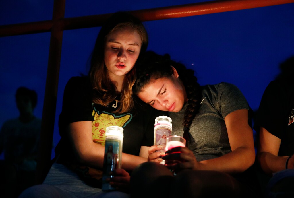 (John Locher | AP) Melody Stout and Hannah Payan comfort each other during a vigil for victims of the shooting that occurred earlier in the day at a shopping center, Saturday, Aug. 3, 2019, in El Paso, Texas.