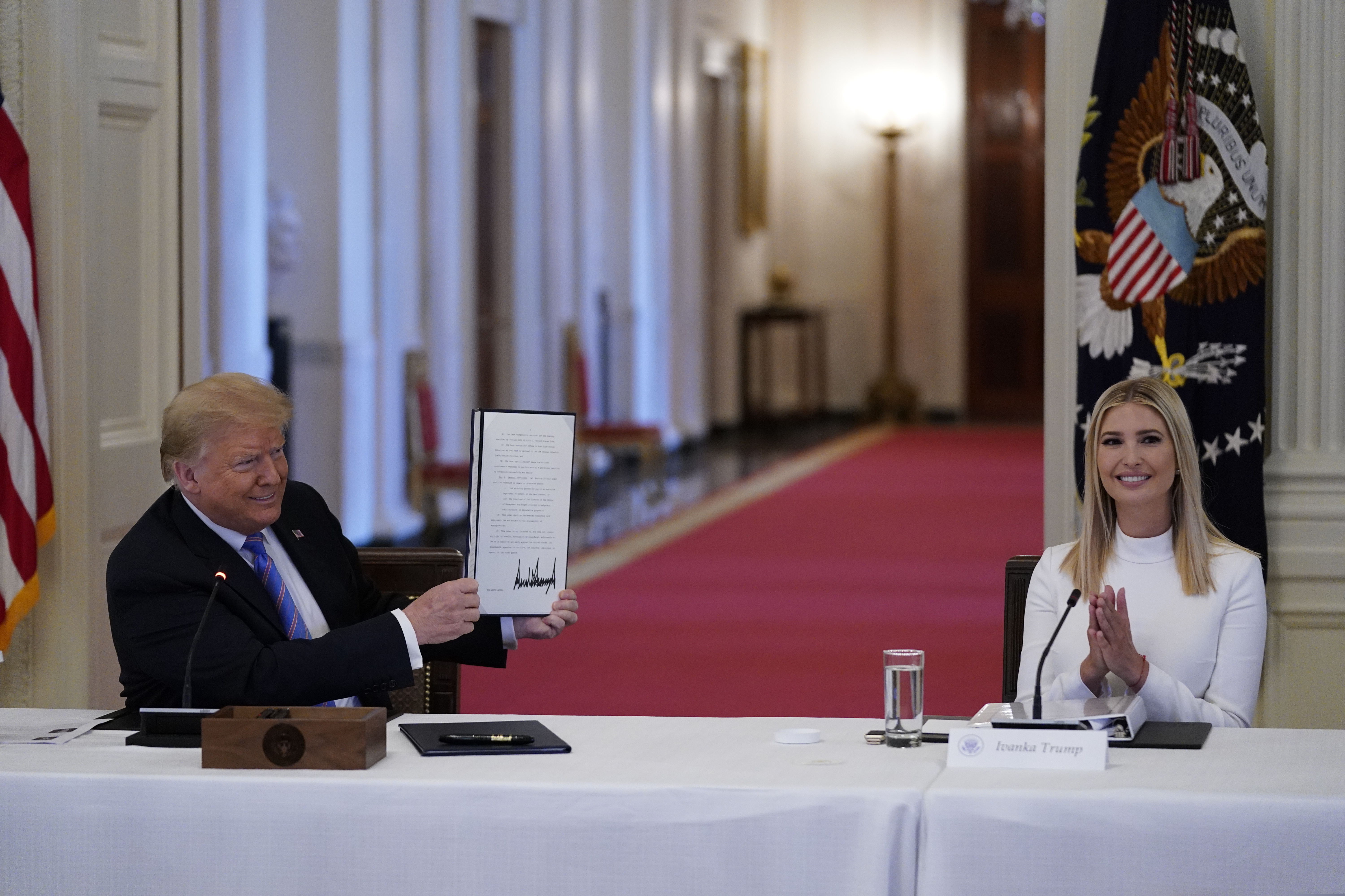 (Evan Vucci | AP photo)

 In this June 26 photo, Ivanka Trump, right, applauds as President Donald Trump holds an executive order that he signed during a meeting with the American Workforce Policy Advisory Board, in the East Room of the White House in Washington. A new White House-backed ad campaign aims to encourage people who are unemployed or unhappy in their jobs or careers to “find something new.”