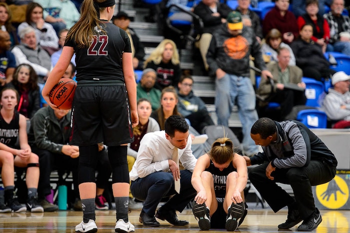 (Trent Nelson | The Salt Lake Tribune)  Northridge's Kendell Petersen (12) is assisted after a hard fall as Bingham faces Northridge in the 6A High School Girls' Basketball Tournament at SLCC in Taylorsville, Thursday Feb. 22, 2018.