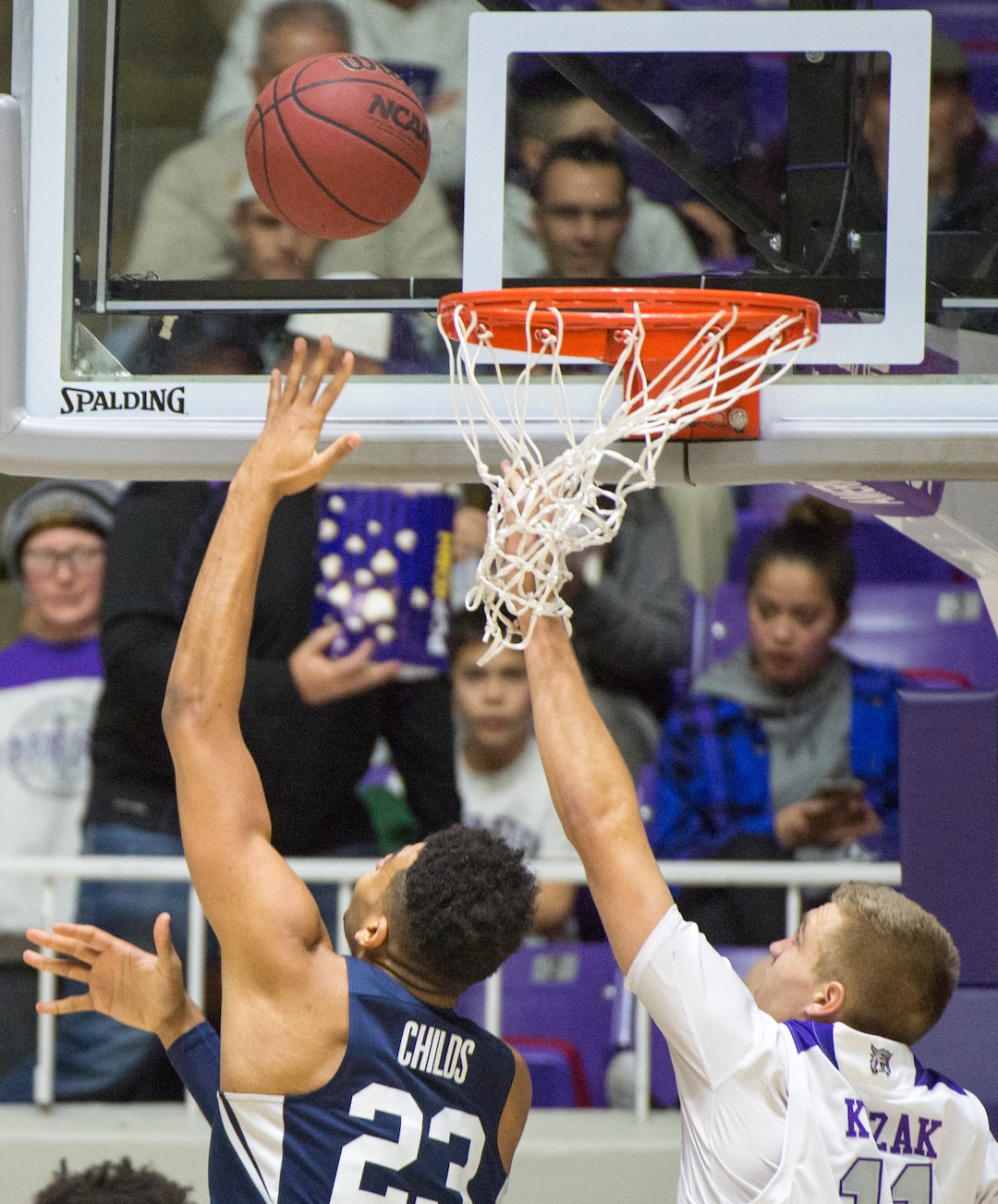 (Rick Egan  |  The Salt Lake Tribune)       Brigham Young Cougars forward Yoeli Childs (23) scores on a reverse layup, as Weber State Wildcats forward Michal Kozak (11) defends, in basketball action between Brigham Young Cougars and Weber State Wildcats, at the Dee Event Center in Ogden, Saturday, Dec. 1, 2018.