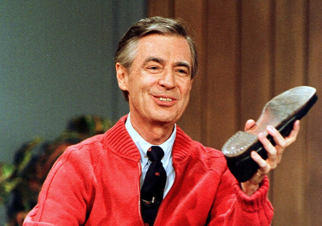 FILE - This June 28, 1989, file photo, shows Fred Rogers as he rehearses the opening of his PBS show "Mister Rogers' Neighborhood" during a taping in Pittsburgh. It’s been 50 years since Fred Rogers first appeared on our TVs, a gentle and avuncular man who warbled "Won't You Be My Neighbor?" The golden anniversary of America’s favorite neighbor’s appearance is being celebrated with a PBS special next month, a new stamp, a feature-length documentary coming out this summer and plans for a Tom Hanks-led biopic. (AP Photo/Gene J. Puskar, File)