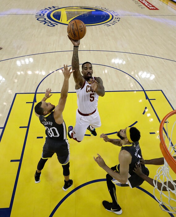 Cleveland Cavaliers guard J.R. Smith (5) shoots against Golden State Warriors guard Stephen Curry (30) and center JaVale McGee during the first half of Game 2 of basketball's NBA Finals in Oakland, Calif., Sunday, June 3, 2018. (AP Photo/Marcio Jose Sanchez, Pool)