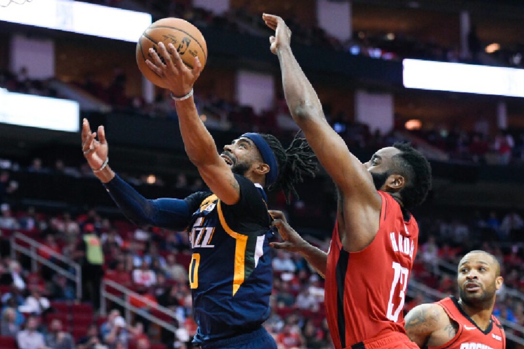 Utah Jazz guard Mike Conley, left, drives to the basket as Houston Rockets guard James Harden defends during the second half of an NBA basketball game, Sunday, Feb. 9, 2020, in Houston. (AP Photo/Eric Christian Smith)