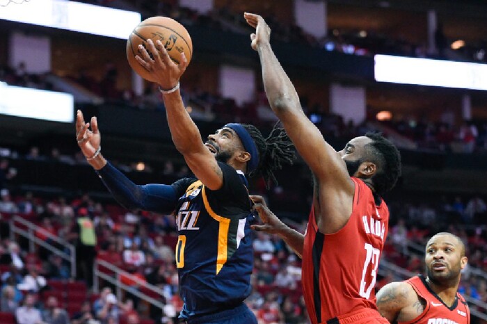 Utah Jazz guard Mike Conley, left, drives to the basket as Houston Rockets guard James Harden defends during the second half of an NBA basketball game, Sunday, Feb. 9, 2020, in Houston. (AP Photo/Eric Christian Smith)