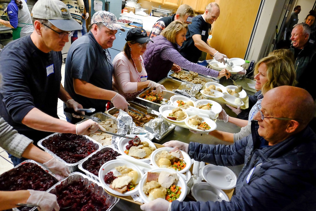 (Francisco Kjolseth | The Salt Lake Tribune) Volunteers prepare plates at the Salt Lake City Mission at 1055 N. Redwood Road in Salt Lake City, as they host a Thanksgiving banquet for the homeless and the hungry on Thursday, Nov. 28, 2019.