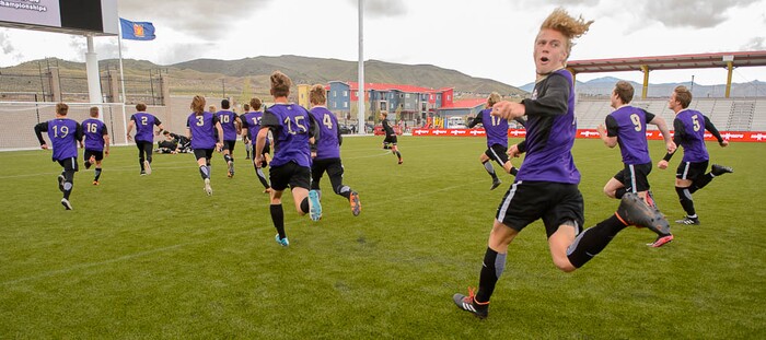 (Trent Nelson | The Salt Lake Tribune)  Desert Hills players celebrate their win over Park City High School in the 4A state championship game, Saturday May 12, 2018.