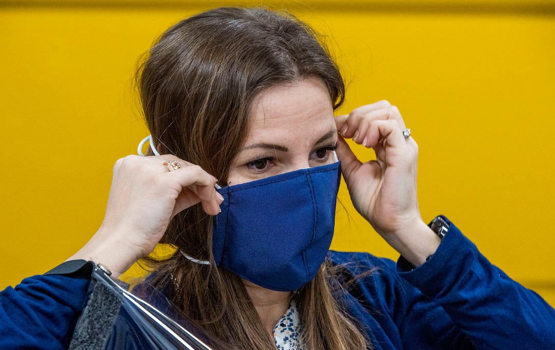 (Rick Egan  |  The Salt Lake Tribune)     Romy Humphries, director of marketing and sales at SugarHouse Industries, demonstrates the make face mask they are producing to protect against coronavirus, Thursday, March 26, 2020.