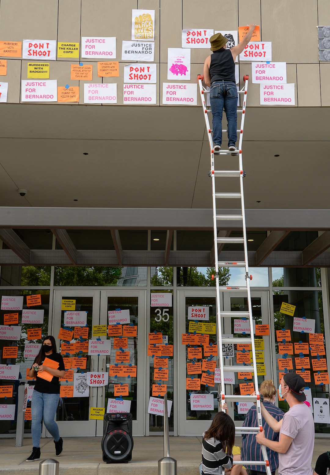 (Francisco Kjolseth  |  The Salt Lake Tribune) A group of about twenty people again showed up at the Salt Lake County District AttorneyÕs Office on Sunday, June 21, 2020, as part of their vow to come out every day until officials release the investigation into Bernardo Palacios-CarbajalÕs death by police. They hung protest signs on the building's windows.