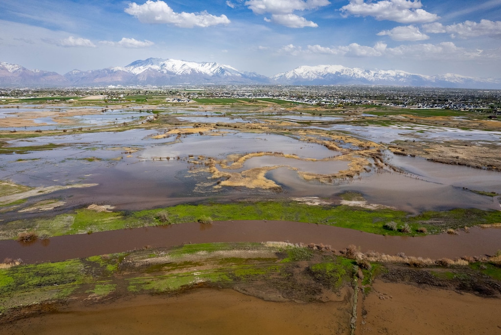(Francisco Kjolseth | The Salt Lake Tribune) High water flow jumps the banks of the Weber River, pictured below, near Farmington Bay as it floods adjacent farmland on Tuesday, May 2, 2023. 