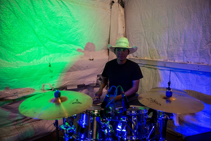 (Adriana Zehbrauskas | The New York Times) Hampton Manuelito sets up a stage at Redd’s Event Center, the site of the Bad Country Music Festival, in Shiprock, N.M., Nov. 9, 2019. At highway honky-tonks, casino lounges and far-flung dance halls, a form of music that many associate with rural white America is flourishing in the heart of Indian country, and no tribe have put their own stamp on country music quite like the Navajo.