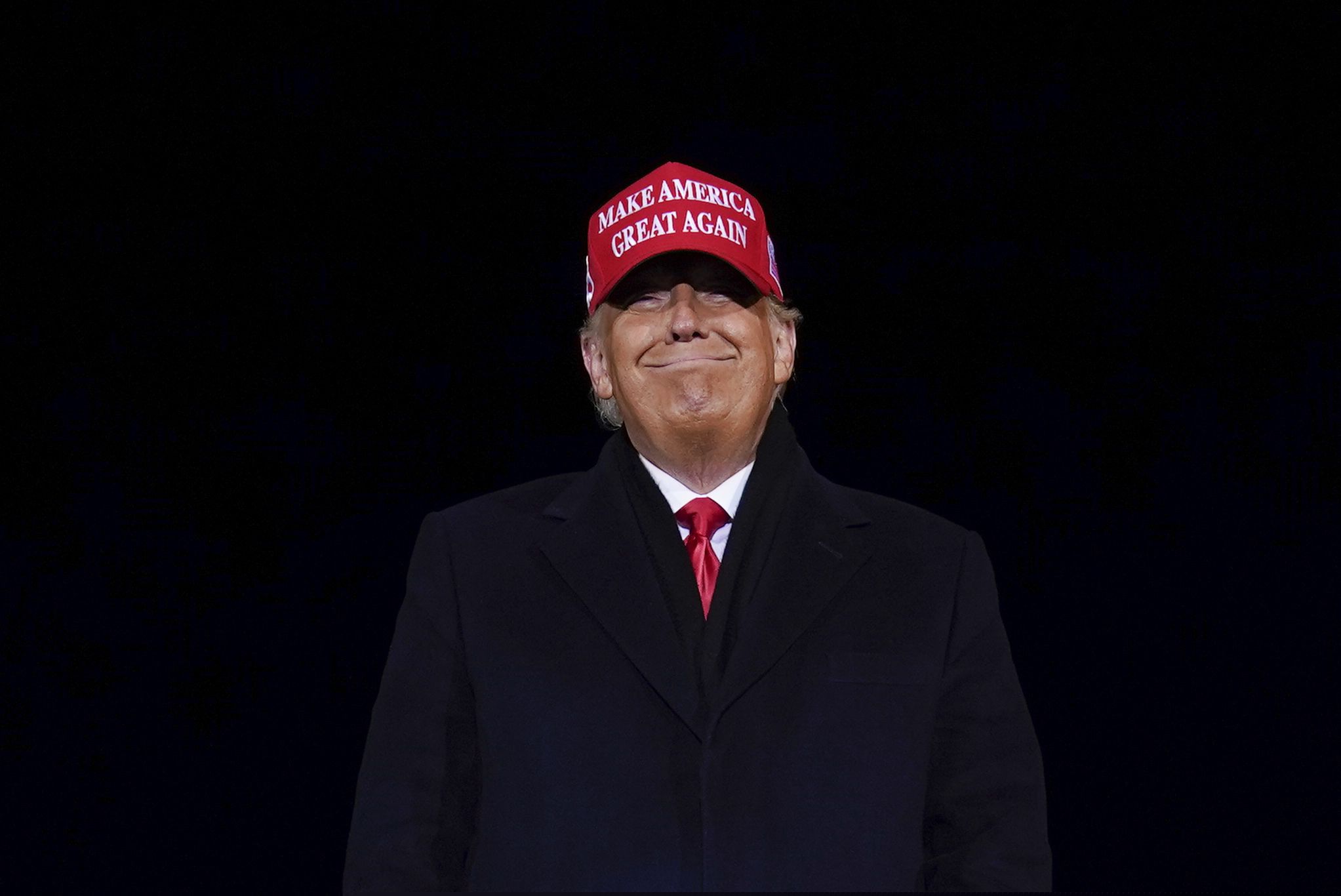 President Donald Trump smiles at supporters after a campaign rally at Gerald R. Ford International Airport, early Tuesday, Nov. 3, 2020, in Grand Rapids, Mich. (AP Photo/Evan Vucci)
