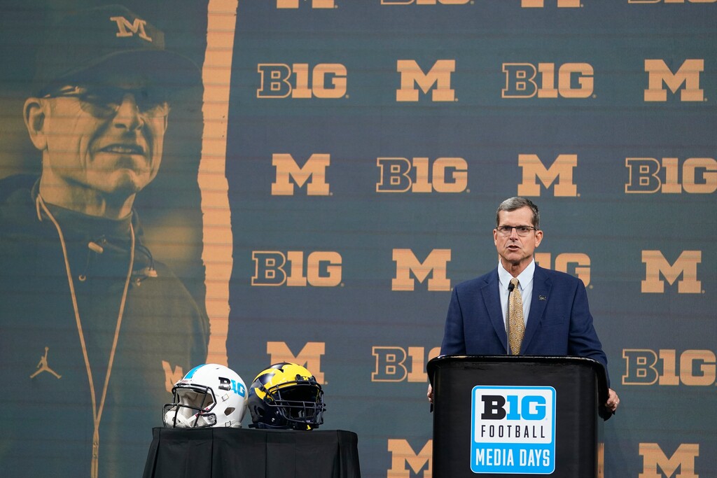 (Darron Cummings | AP) Michigan head coach Jim Harbaugh talks to reporters during an NCAA college football news conference at the Big Ten Conference media days, at Lucas Oil Stadium, Tuesday, July 26, 2022, in Indianapolis.