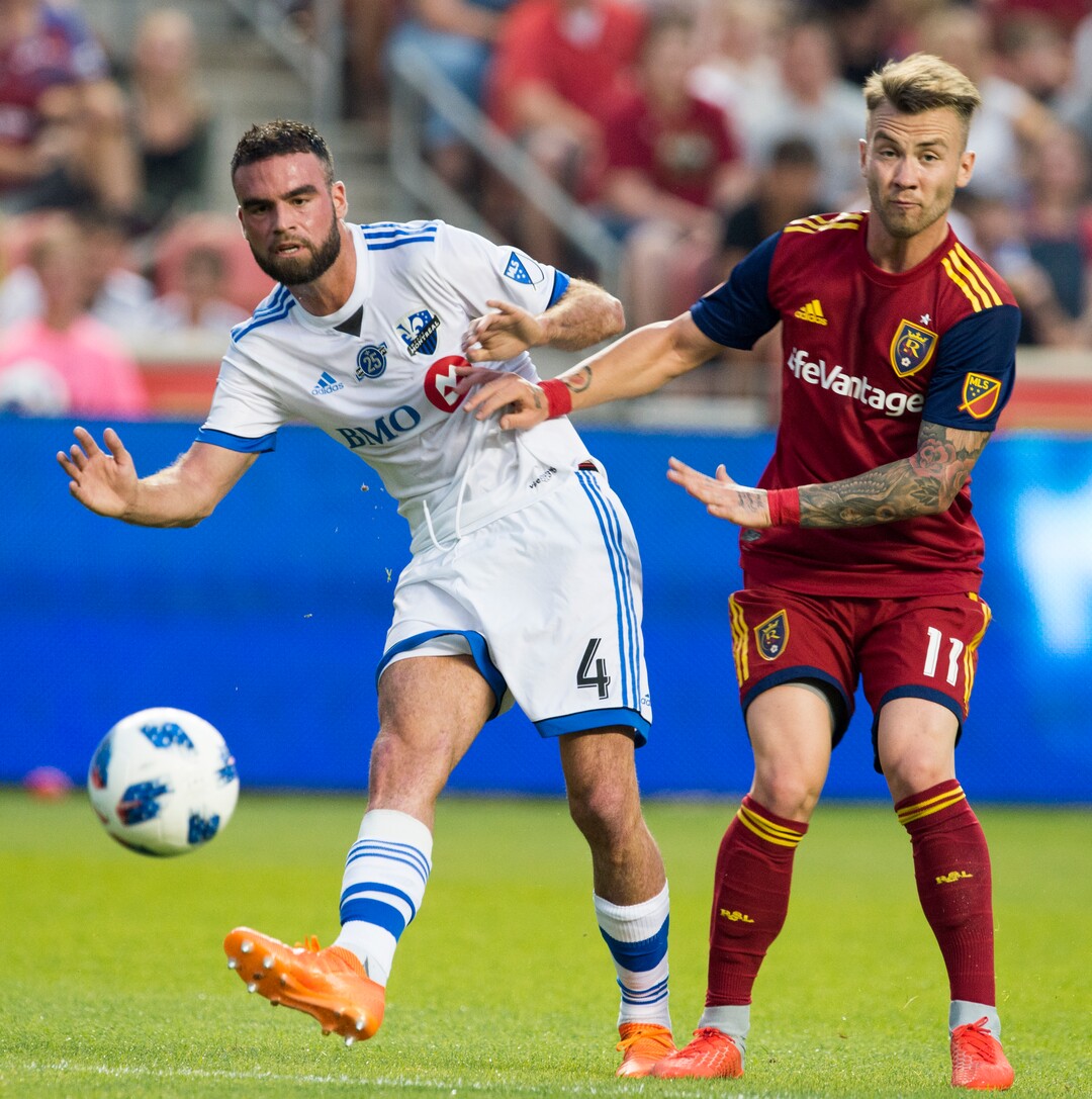 Real Salt Lake midfielder Albert Rusnak (11) makes contact with Montreal Impact defender Rudy Camacho (4) in MLS soccer game action in Sandy, Utah, Saturday, Aug. 11, 2018. (Rick Egan/The Salt Lake Tribune via AP)