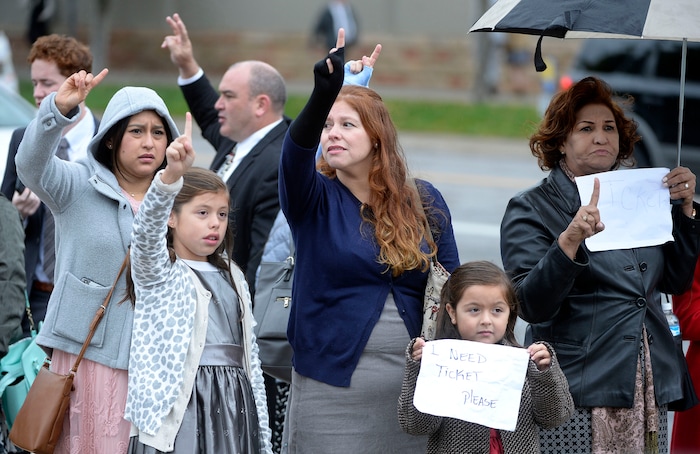 (Al Hartmann  |  The Salt Lake Tribune) 	
Members of the Church of the Jesus Christ of Latter Day Saints signal for any extra tickets to attend General Conference Oct. 1 2017. 