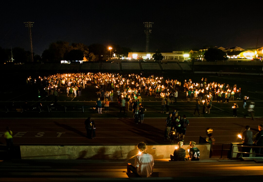 (Rick Egan  |  The Salt Lake Tribune)Hillcrest high students and supporters gather on the Hillcrest football field for a candlelight vigil in honor of coach Cazzie Brown, at Hillcrest High School, Monday, August 28, 2017.
