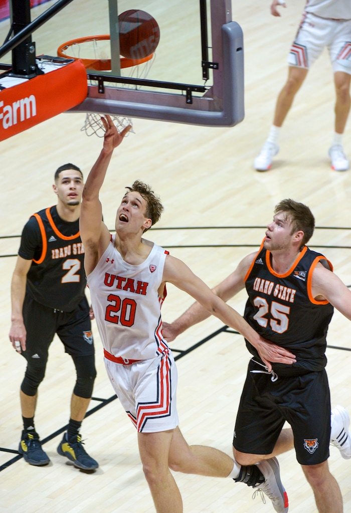 (Leah Hogsten  |  The Salt Lake Tribune) Utah Utes forward Mikael Jantunen (20) with the layup on Idaho State Bengals guard Tarik Cool (2) and Idaho State Bengals center Brayden Parker (25) during their NCAA basketball matchup Tuesday, Dec. 8, 2020 at the Jon M. Huntsman Center.