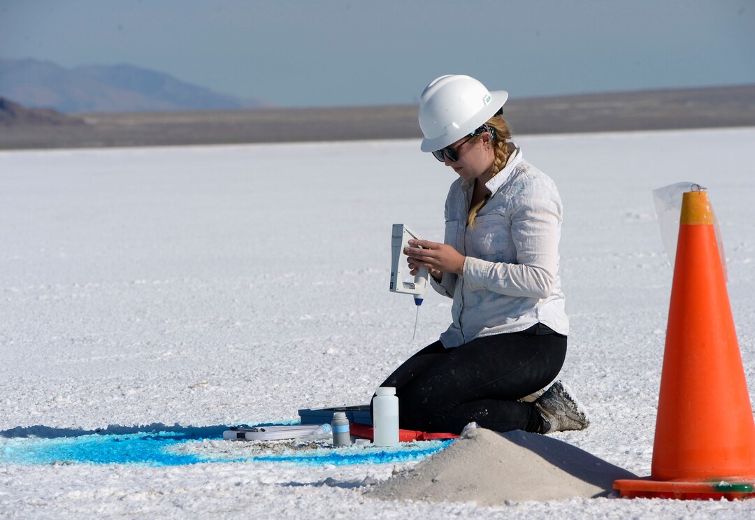 (Al Hartmann  |  Tribune file photo) University of Utah undergraduate research assistant Lily Wetterlan takes a chemistry reading from brine drilled from a hole on the Bonneville Salt Flats on Sept. 6, 2017.  University of Utah scientists are studying the degradation of the Bonneville Salt Flats and are making 70 exploratory bore holes and taking measurements of salt crust thickness and composition.