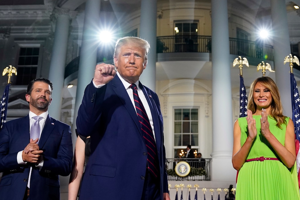 (Evan Vucci | AP photo)

From left, Donald Trump Jr., President Donald Trump and first lady Melania Trump stand on the South Lawn of the White House Thursday, the fourth day of the Republican National Convention.