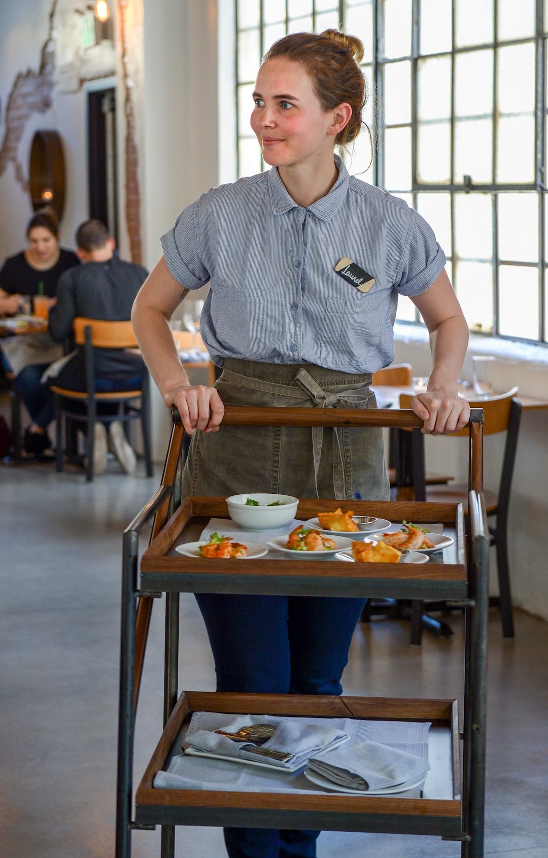 Leah Hogsten  |  The Salt Lake Tribune SLC Eatery server Laurel Clayson pushes a tiered metal cart Ñ filled with plates of appetizer-size morsels Ñfrom table to table, allowing diners to pick what they want to eat. SLC EateryÕs regular menu and the cart offerings include globally inspired flavors of Latin America, the Mediterranean and Asia.