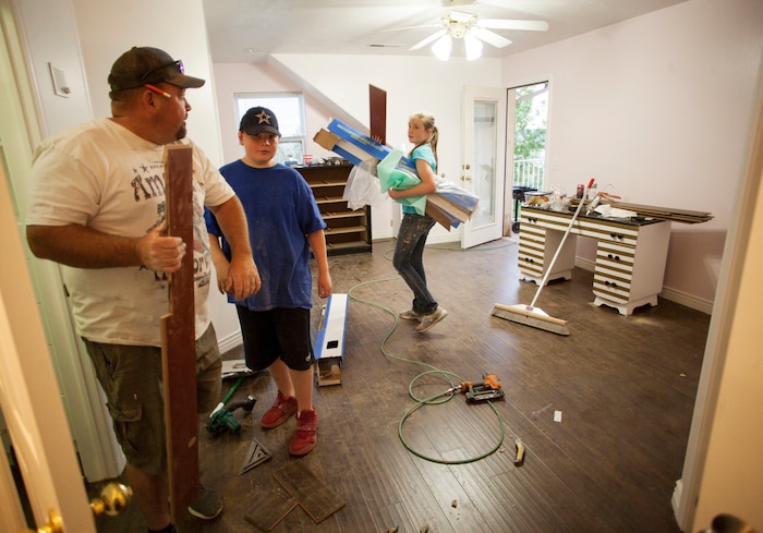 In this April 30, 2018, photo, people work to renovate the Short Creek Dream Center, formally the home of polygamous sect leader Warren Jeffs in Hildale, Utah. The sprawling house surrounded by towering brick walls has been converted into a sober living center by Evangelical missionaries, the latest sign of the group’s dwindling control of the small community on the Utah-Arizona border. (Chris Caldwell/The Spectrum via AP)