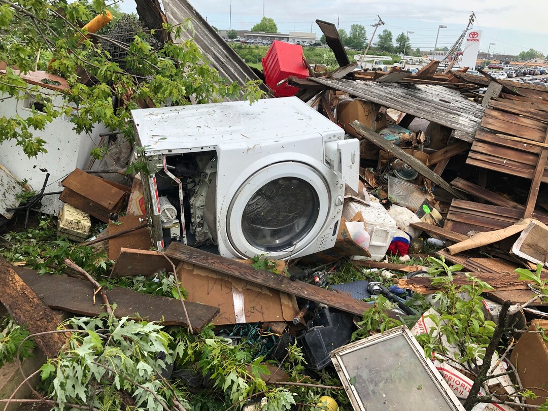 (Summer Ballentine | AP) Debris from a home that David Surprenant rents with his family is scattered across the lawn Thursday, May 23, 2019, the morning after a tornado hit Jefferson City, Mo. Surprenant said his family fled to the basement while he watched the sky outside.  Officials are going door-to-door to survey damage after a tornado ripped a 3-mile path through Missouri's capital city. The destruction in Jefferson City was part of an outbreak of severe weather overnight.