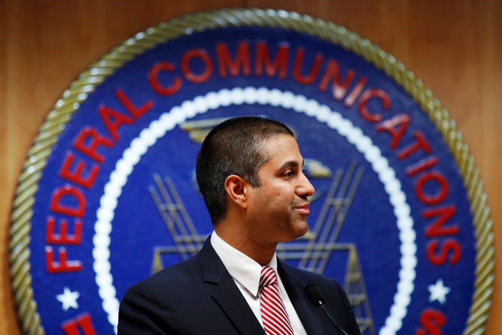 (Jacquelyn Martin | The Associated Press) In this Dec. 14, 2017, file photo, after a meeting voting to end net neutrality, Federal Communications Commission Chairman Ajit Pai smiles while listening to a question from a reporter in Washington. The FCC has set June 11 as the repeal date for “net neutrality” rules meant to prevent broadband companies from exercising more control over what people watch and see on the internet. Pai says the repeal aims to replace “heavy-handed” rules with a “light-touch” approach to internet regulation.