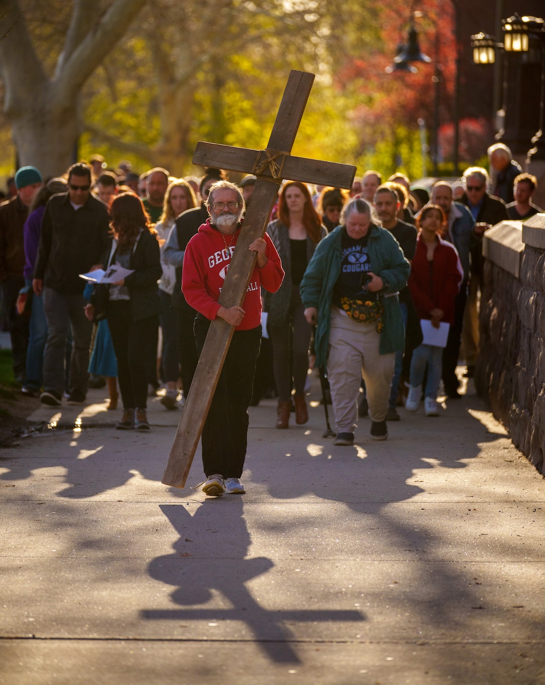 (Trent Nelson  |  The Salt Lake Tribune) Alex Bury carries the cross as a Good Friday procession begins at the Cathedral of the Madeleine in Salt Lake City on Friday, April 15, 2022.