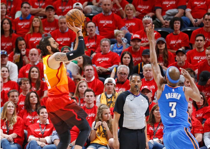 Utah Jazz guard Ricky Rubio, left, shoots as Oklahoma City Thunder forward Corey Brewer, right, defends in the first half during Game 3 of an NBA basketball first-round playoff series Saturday, April 21, 2018, in Salt Lake City. (AP Photo/Rick Bowmer)