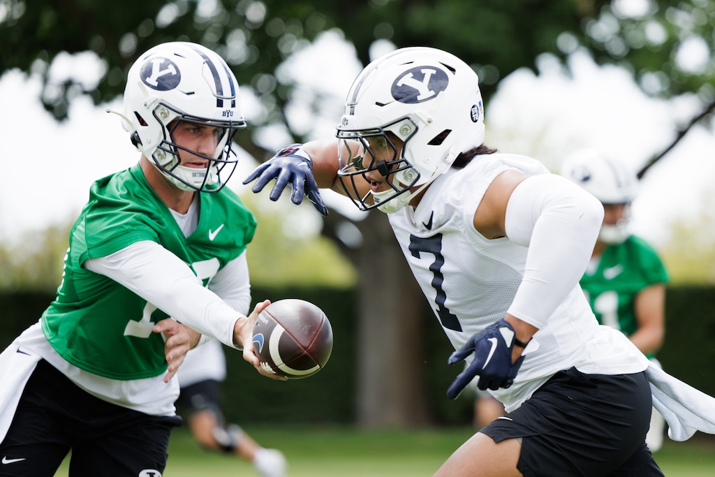 (Jaren Wilkey | BYU) Quarterback Kedon Slovis, left, and running back Hinckley Ropati participate in the first day of BYU football fall camp in Provo, Tuesday, Aug. 1, 2023.
