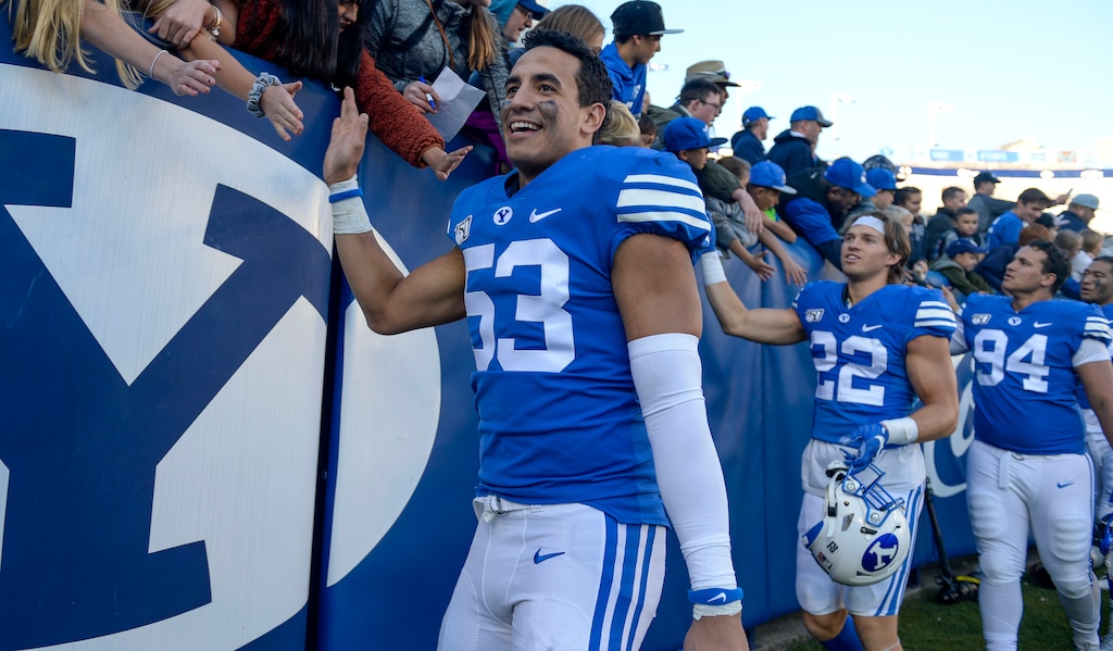 (Leah Hogsten  |  The Salt Lake Tribune) Brigham Young Cougars linebacker Isaiah Kaufusi (53) celebrates the win with fans. Brigham Young University defeated  Idaho State 41-10, Saturday, Nov. 16, 2019 at LaVell Edwards Stadium. 