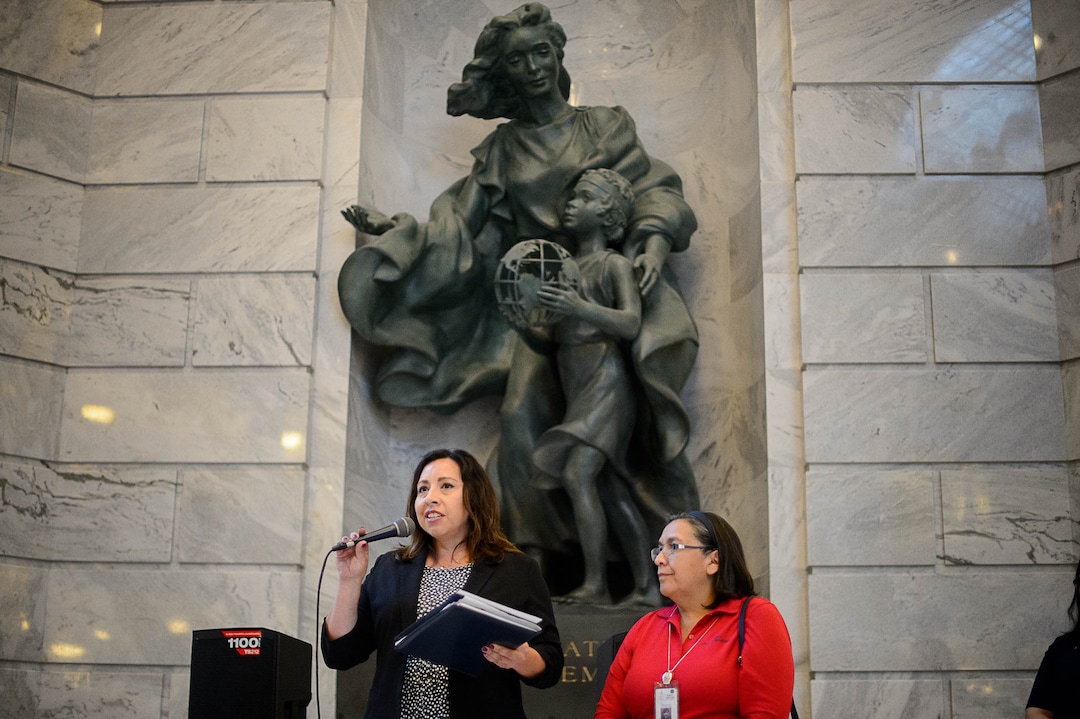(Trent Nelson | The Salt Lake Tribune)  Rep. Angela Romero, D-Salt Lake City and Rep. Rebecca Chavez-Houk, D-Salt Lake City, speak under a statue dedicated to Immigration and Settlement at a rally at the State Capitol building in Salt Lake City to "remind Senator Hatch and Senator Lee that DACA is #HereToStay, Thursday August 31, 2017.