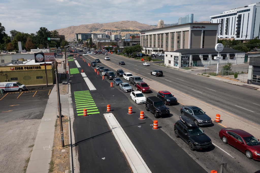 (Bethany Baker  |  The Salt Lake Tribune) Construction of a protected bike path extension along 300 West continues in Salt Lake City on Friday, July 18, 2025.