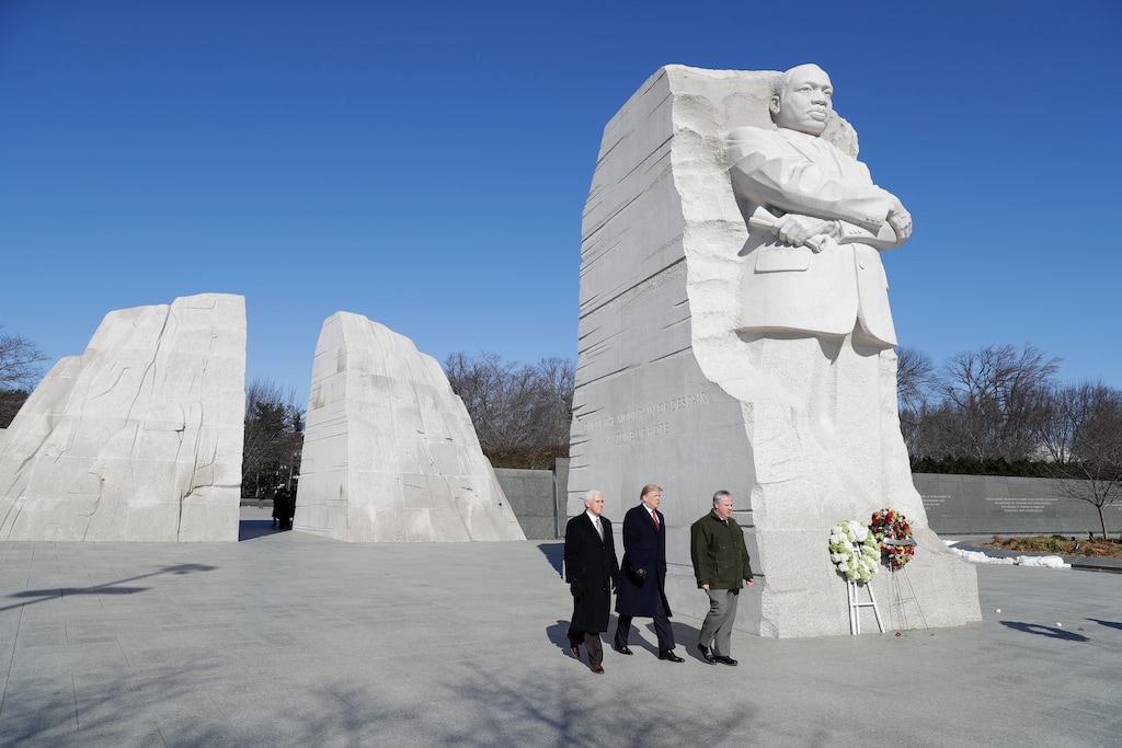 President Donald Trump, center, Vice President Mike Pence, left, escorted by Acting Interior Secretary David Bernhardt, right, visit the Martin Luther King Jr. Memorial, Monday, Jan. 21, 2019, in Washington. (AP Photo/ Evan Vucci)