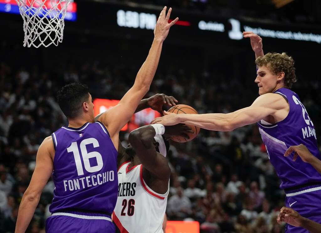 (Bethany Baker  |  The Salt Lake Tribune) Utah Jazz forward Lauri Markkanen (23) fouls Portland Trail Blazers center Duop Reath (26) as Utah Jazz forward Simone Fontecchio (16) defends in Salt Lake City on Tuesday, Nov. 14, 2023.