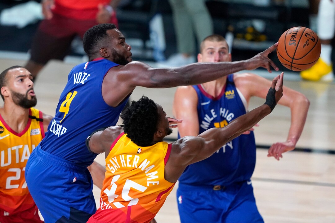 Denver Nuggets' Paul Millsap (4) knocks the ball away from Utah Jazz's Donovan Mitchell (45) during the second half of an NBA basketball first round playoff game Sunday, Aug. 23, 2020, in Lake Buena Vista, Fla. (AP Photo/Ashley Landis, Pool)