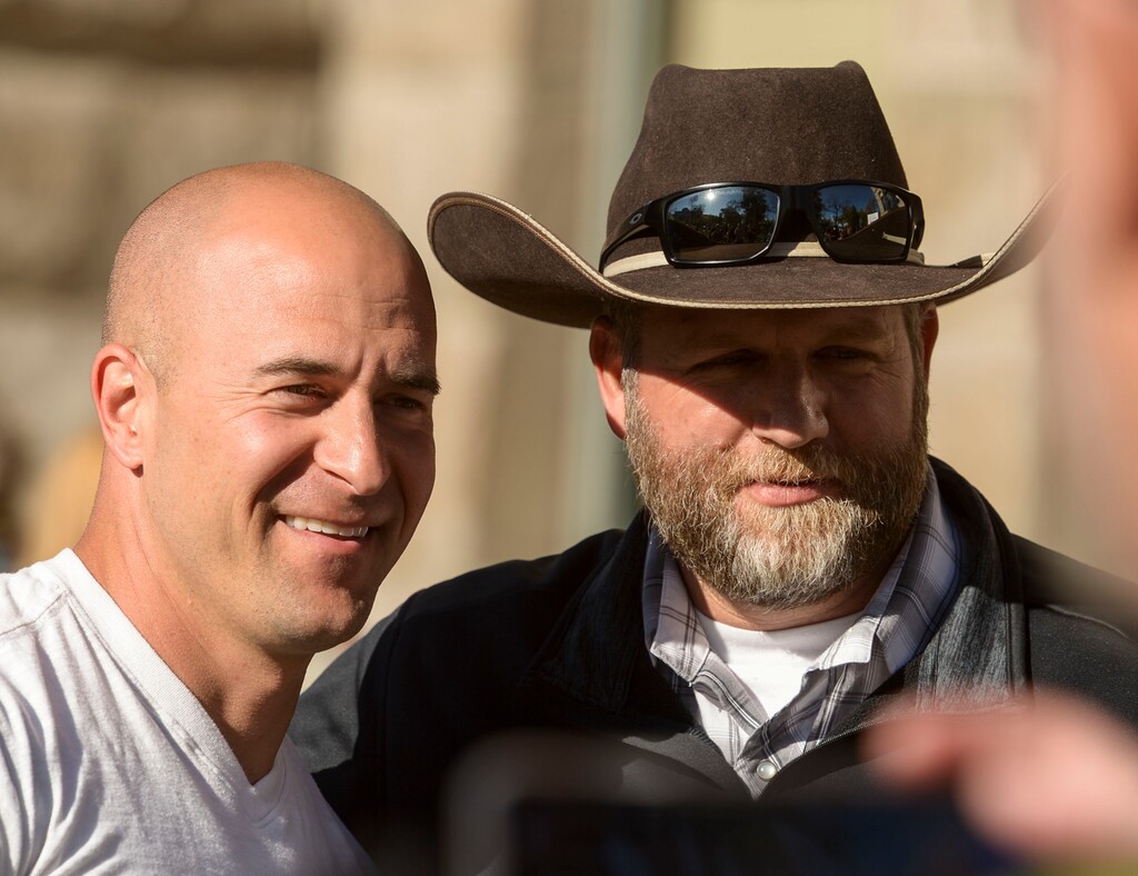 (Leah Hogsten | The Salt Lake Tribune) l-r Eric Moutsos, event organizer and Ammon Bundy pose for a photo. About 1,000 people protested the government mandated shutdown of businesses on the grounds of Salt Lake City Hall, Saturday. The protest was organized by Utah Business Revival aimed at Mayor Erin Mendenhall, Salt Lake County Mayor Jenny Wilsonand Governor Gary Herbert policies on COVID-19 and social distancing, April 18, 2020.