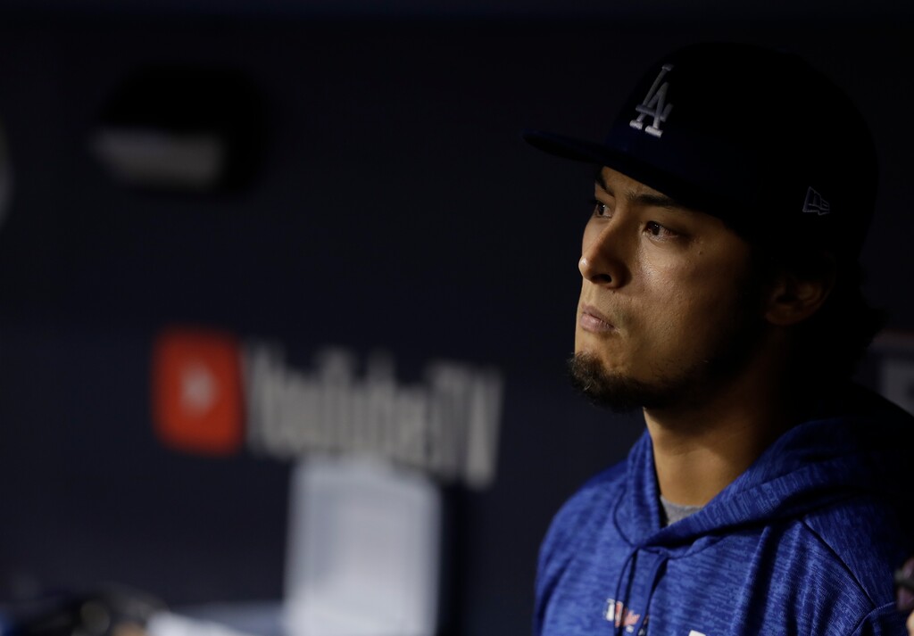 Los Angeles Dodgers' Yu Darvish watches from the dugout during the eighth inning of Game 7 of baseball's World Series against the Houston Astros Wednesday, Nov. 1, 2017, in Los Angeles. (AP Photo/Matt Slocum)