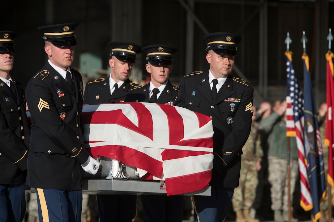 (Matt Herp  |  The Ogden Standrad Examiner/Pool) Utah National Guard Honor Guard Detail members carry a casket containing the remains of Maj. Brent R. Taylor at Roland R. Wright Air National Guard Base in Salt Lake City, Utah, on Wednesday, Nov. 14, 2018. Taylor, 39, of North Ogden, died Nov. 3, 2018, in Afghanistan of wounds sustained from small arms fire. His funeral is scheduled for Saturday, Nov. 17, in Ogden.