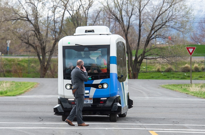 (Rick Egan  |  The Salt Lake Tribune)   Lt. Governor Spencer J. Cox walks in front of an Autonomous Shuttle, to see if it will stop for him, during a demonstration as the Utah Department of Transportation, in partnership with the Utah Transit Authority, launched a new Autonomous Shuttle Pilot Project at the test track is across the street from UDOT headquarters on the west side of 2700 West. Thursday, April 11, 2019.


