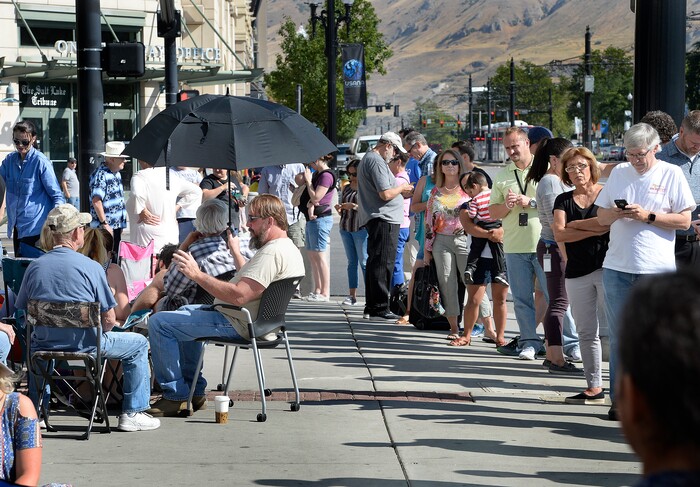 (Scott Sommerdorf | The Salt Lake Tribune) Hundreds of hopeful eclipse-watchers line up outside the Clark Planetarium in hopes of getting eclipse glasses from the gift shop, Thursday, August 17, 2017.