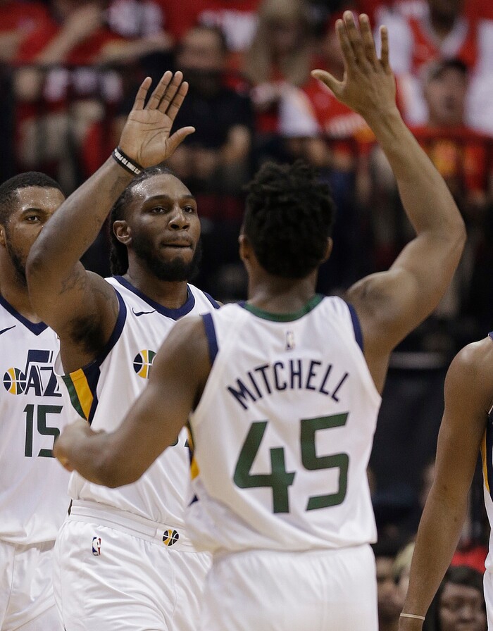 Utah Jazz forward Jae Crowder, left, high-fives guard Donovan Mitchell after drawing a foul during the first half in Game 2 of an NBA basketball second-round playoff series against the Houston Rockets, Wednesday, May 2, 2018, in Houston. (AP Photo/Eric Christian Smith)