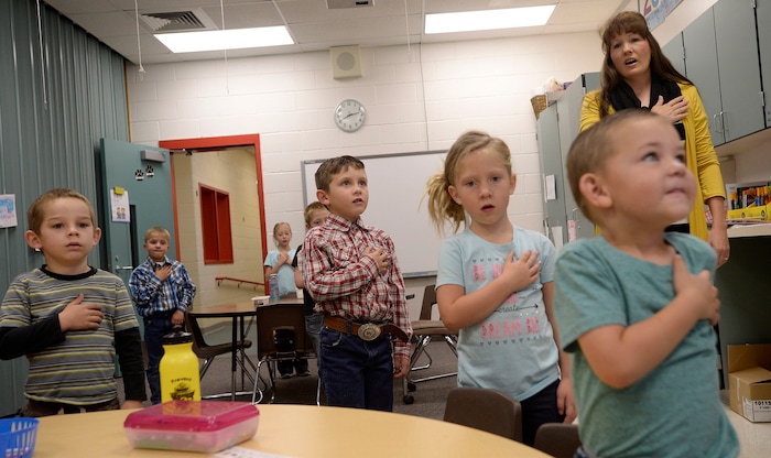(Al Hartmann | The Salt Lake Tribune) Melissa Morris at Park Valley School leads K-2nd graders in the Pledge of Allegiance Wednesday August 30.