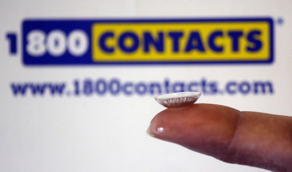 FILE - In this May 13, 2015, file photo, a contact lens is displayed in front of a 1-800-Contacts shipping box in Salt Lake City. A legal battle over a hotly contested Utah law banning minimum prices for contact lenses is set to come before a federal appeals court on Thursday, Aug. 27, 2015. (AP Photo/Rick Bowmer, File)