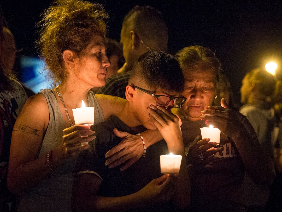 (Nick Wagner  |  Austin American-Statesman via AP)  Mona Rodriguez holds her 12-year-old son, J Anthony Hernandez, during a candlelight vigil held for the victims of a fatal shooting at the First Baptist Church of Sutherland Springs, Sunday, Nov. 5, 2017, in Sutherland Springs, Texas.